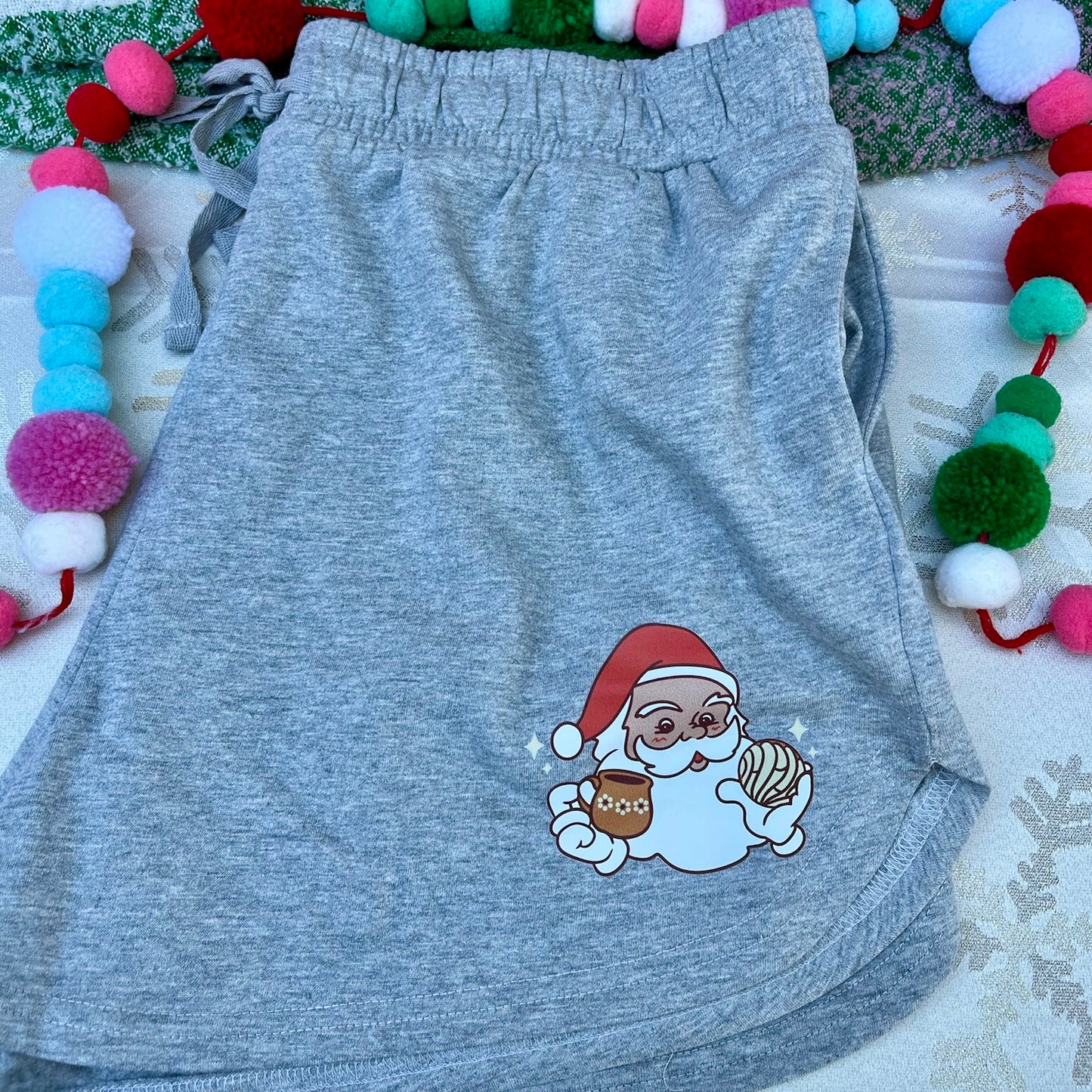 Women’s Gray Jogger Shorts with a Santa holding a concha